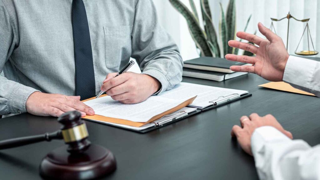 Lawyer reviewing legal documents during a client consultation