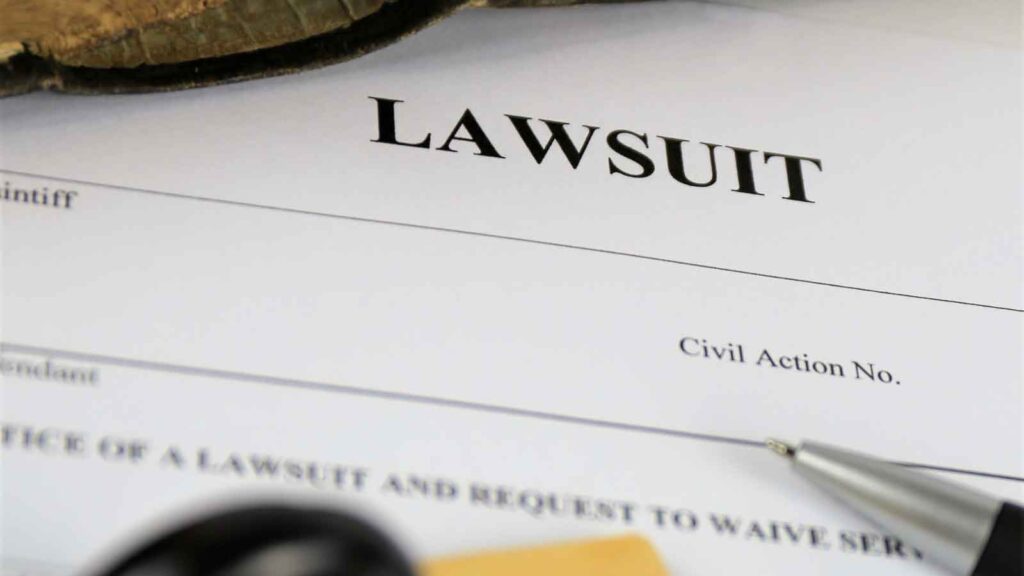 Legal document titled _Lawsuit_ with a pen on top