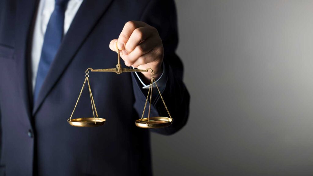 A lawyer holding a scale of justice.