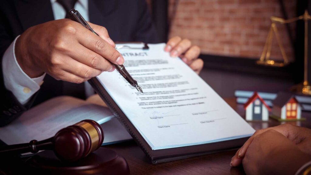 Lawyer pointing at a contract document with a pen.