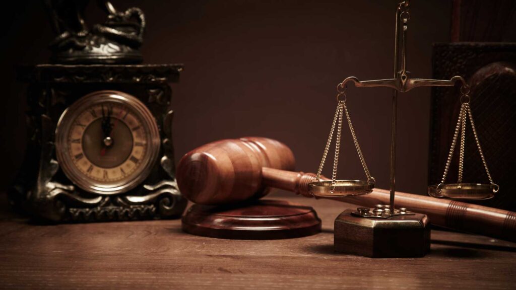 Gavel and scales of justice on a wooden desk.