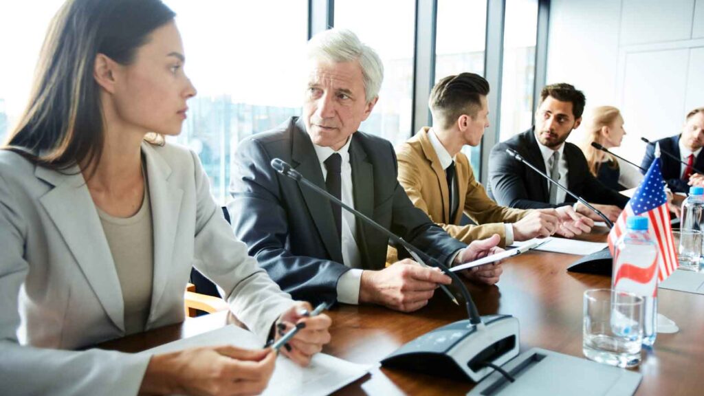 A group of professionals having a discussion in a conference room.