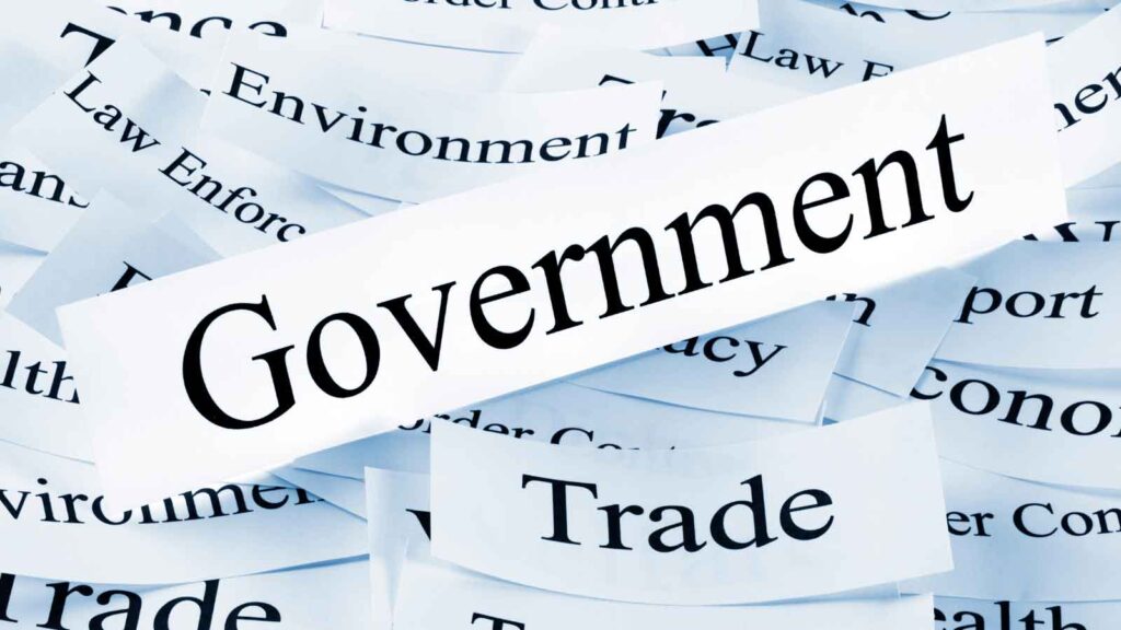 Various words related to government and trade on paper cutouts.